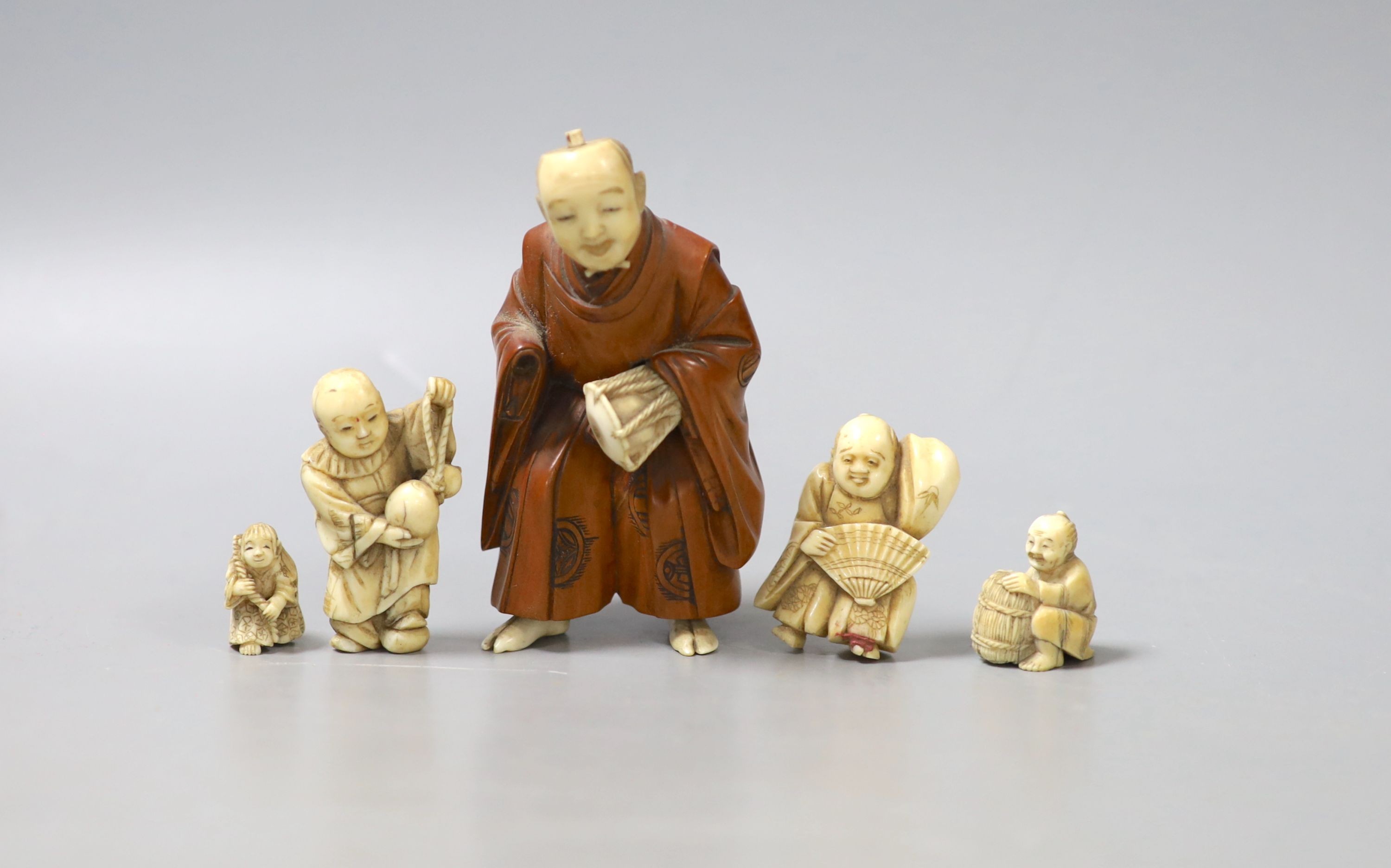 Three Japanese ivory netsuke, a similar okimono and a boxwood and ivory okimono, 9cm (losses)